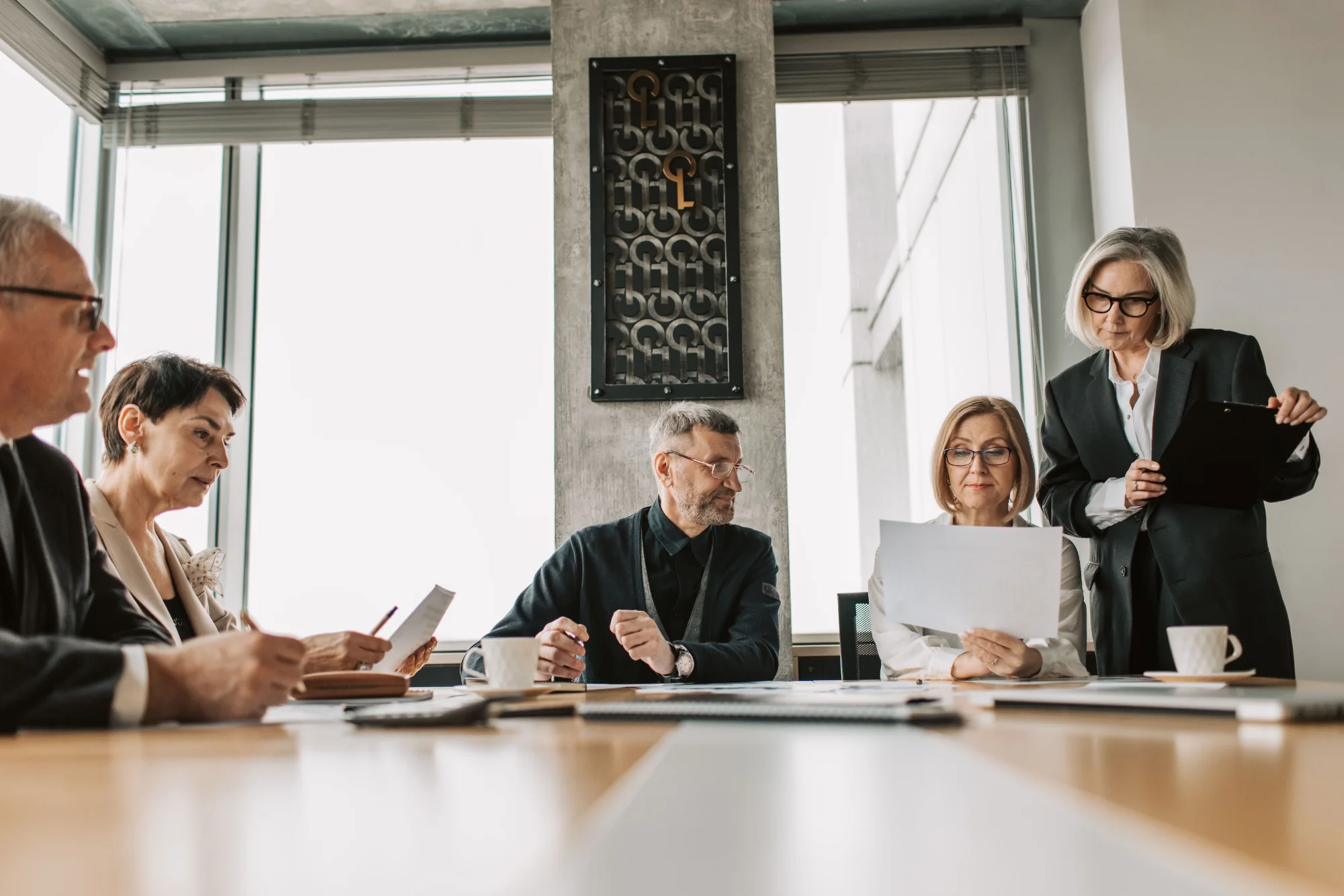 Executive board members meeting to review AI strategy, governance, and financial ROI metrics