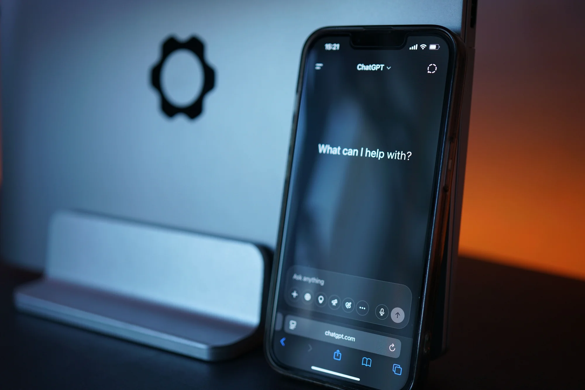 Smartphone displaying ChatGPT prompt on desk