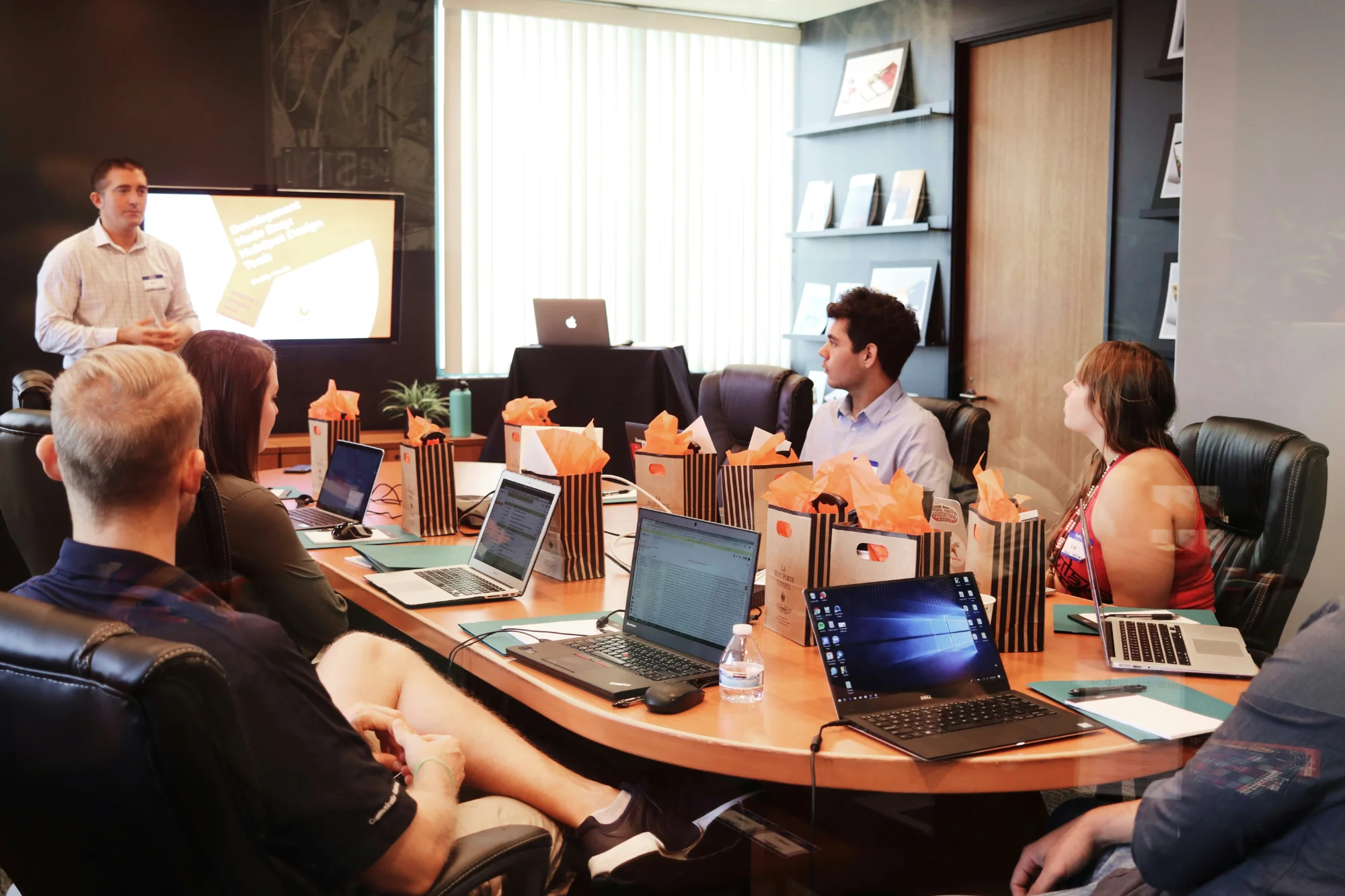 Team meeting with laptops in conference room