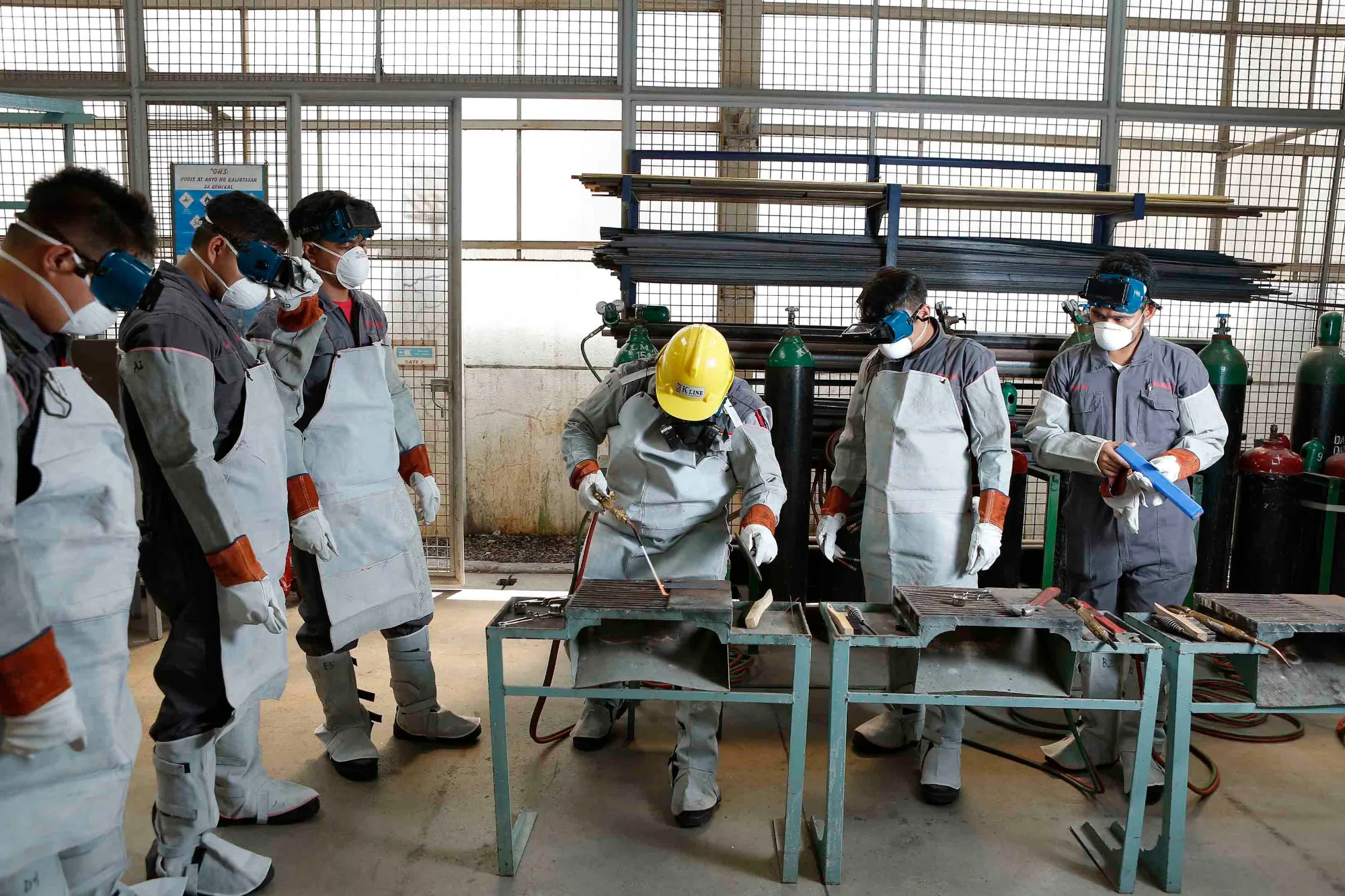 Workers receiving practical safety training in a workshop
