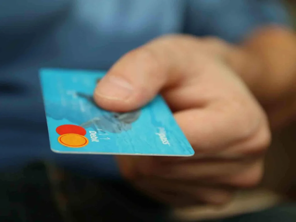 Hand holding a debit card