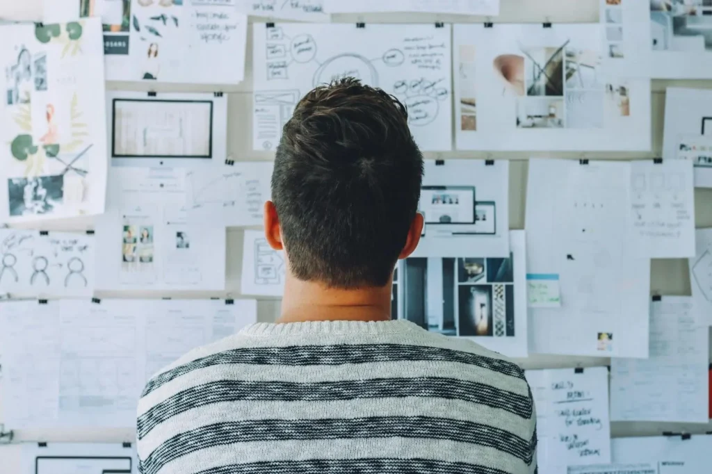 Person looking at a wall covered with notes