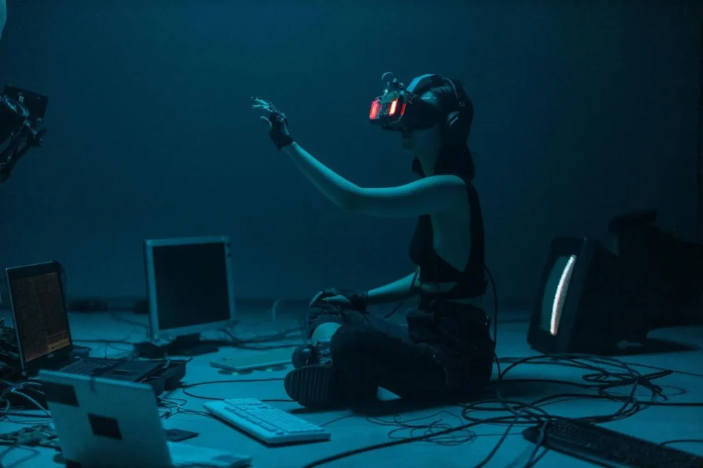 Person using VR headset in a dark tech setup