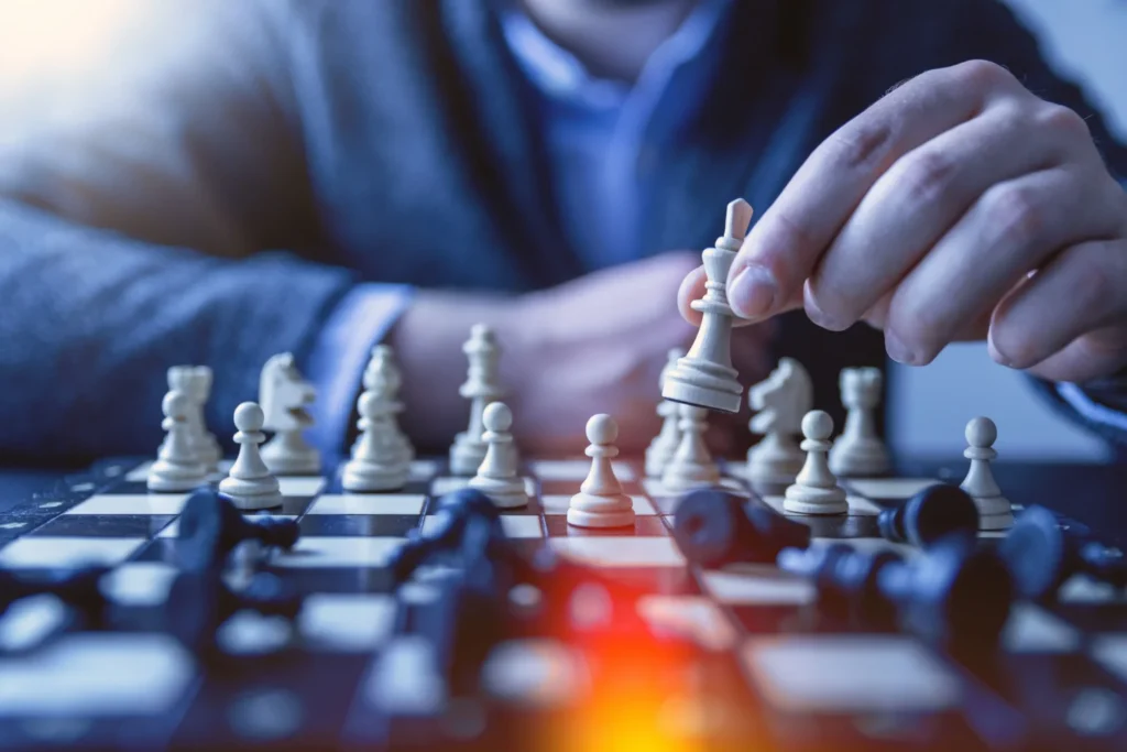 Close up of a businessman playing chess, symbolizing strategic decision intelligence ROI and enterprise AI planning. 